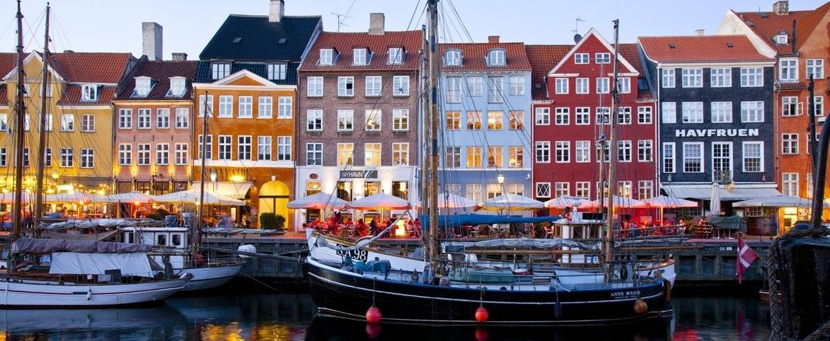 Houses in different colours behind a dock with boats