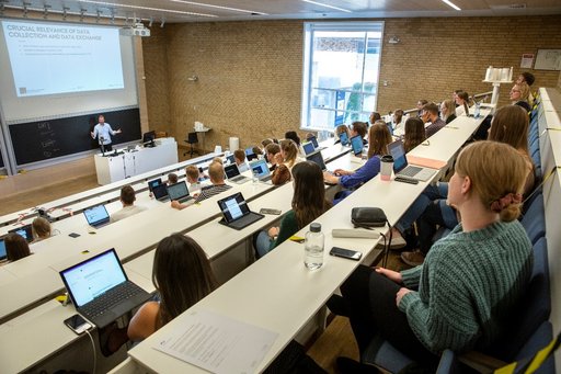 Classroom with couple of students and projector in the front