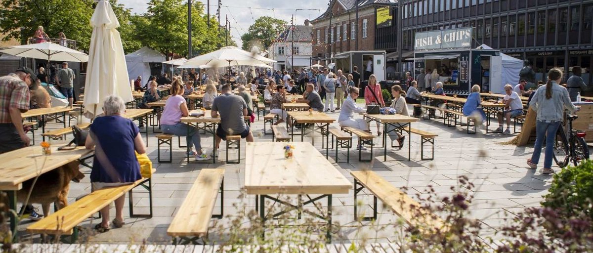 People eating on benches at a street food festival