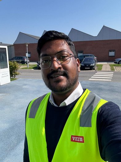 Man taking a selfie in a neon yellow work vest