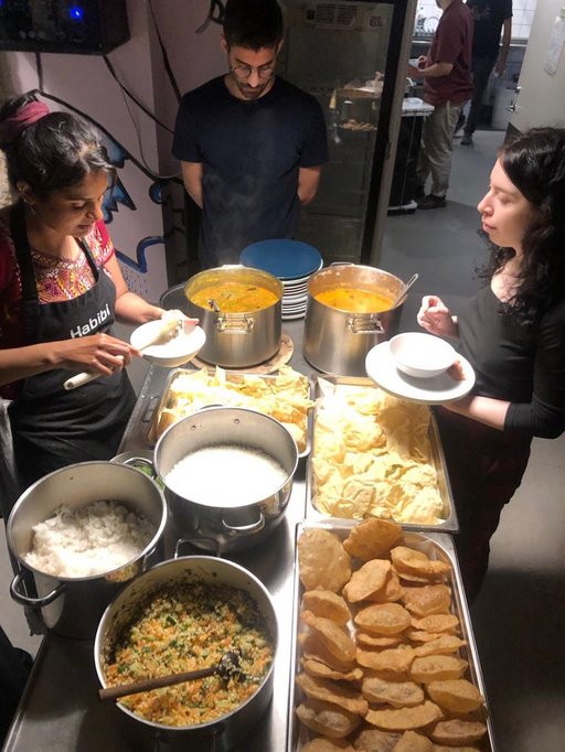 Shared meal with 3 people around a table