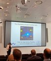 Professor Anja-Verena Mudring holding a lecture in front of a small group of people.