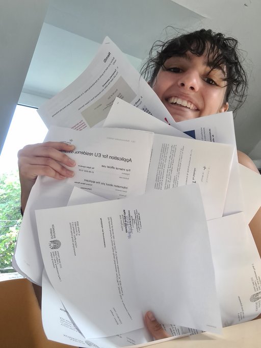 A girl holding a bunch of papers