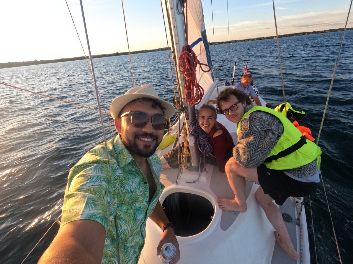 A selfie of three people on a sailing boat