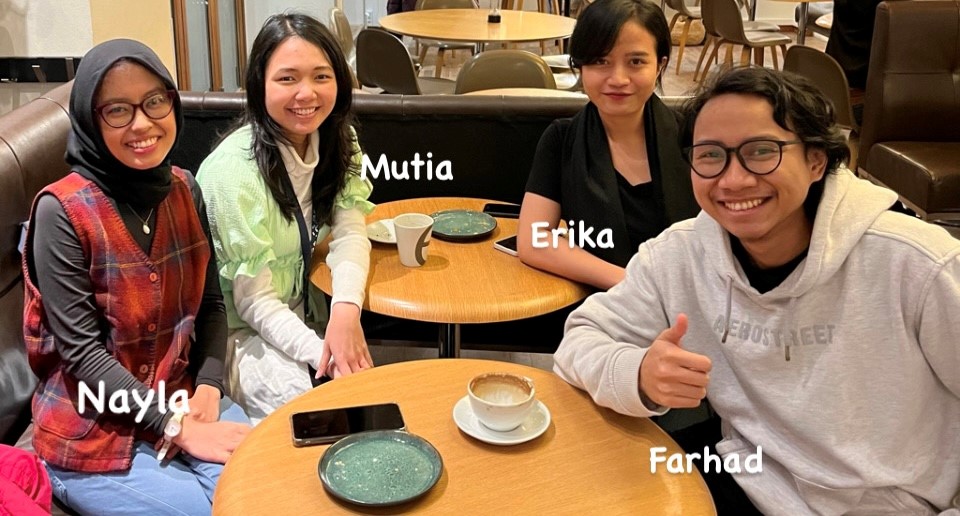 4 indonesian students sitting around table in a cafe